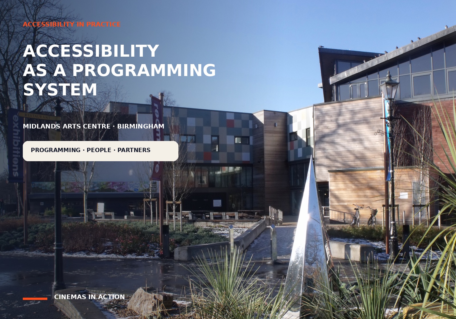 The exterior of Midlands Arts Centre in Cannon Hill Park, Birmingham, with an editorial title about accessibility as a programming system.